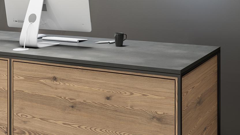 Detailaufnahme Schreibtisch aus Holz Detailaufnahme von Schreibtisch mit Computer Rückseite